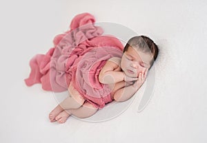 Beautiful sleeping newborn lying on side