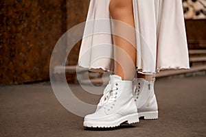 Beautiful slender girl legs and in white shoes, silk dress, bride outfit