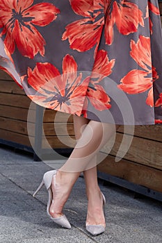 Beautiful slender legs tanned skin is shod in high-heeled shoes