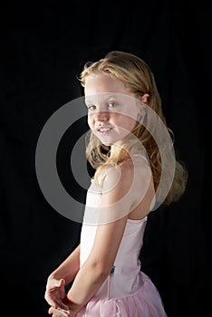 Beautiful slender young girl athlete on a black background