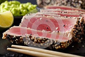 Beautiful sliced tuna steak in sesame and wasabi, lime macro. ho