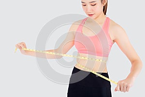 Beautiful slim young asian woman measuring tape thin waist wear uniform fitness isolated white background