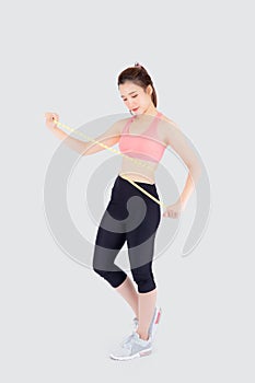 Beautiful slim young asian woman measuring tape thin waist wear uniform fitness isolated white background