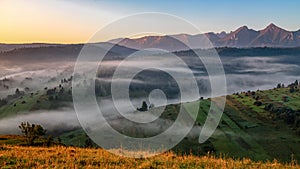 Beautiful landscape with valleys, lakes and rivers in fog under High Tatras