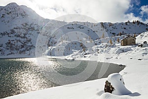 Beautiful small alpine lake in winter season landscape