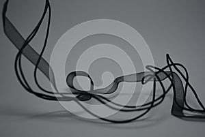 Beautiful small black long ropes, transparent black ribbon beautifully placed on white background.