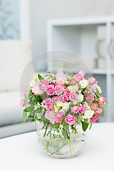 Beautiful small bouquet with roses in glass vase