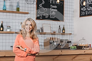 beautiful small business owner smiling at camera while standing