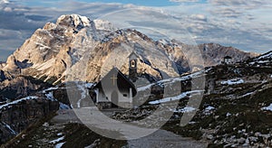 Beautiful small church in the snowy Italian Alps on winter