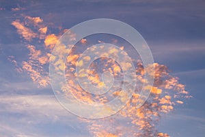 Beautiful small clouds during the sun fall. The golden hour paints the clouds of warm colors