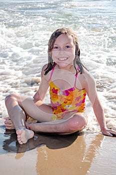 Beautiful little girl enjoying a sunny day on the beach