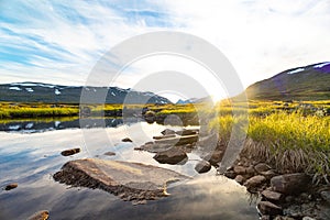 A beautiful small mountain lake in Sarek National Park, Sweden during august.