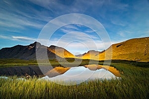 A beautiful small mountain lake in Sarek National Park, Sweden during august.