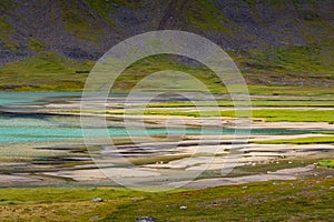 A beautiful small mountain lake in Sarek National Park, Sweden during august.