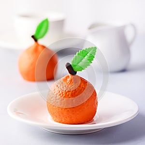 Beautiful Small Mousse Cake in Shape of Citrus Mandarin Tasty Modern Dessert Pastry White Blue Background Cup of Coffee