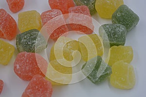 Beautiful, small pieces of gummy confections. Delicious, natural, fruity marmalade in green, yellow, red colors.