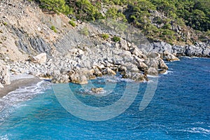 Beautiful small rocky beach with clear blue sea. Oludeniz, Turkey