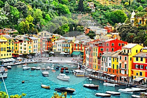 The beautiful small village Portofino with colorfull houses, luxury boats and yacht in little bay harbor.