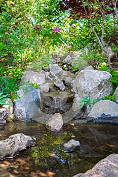 Beautiful small waterfall in a japanese style garden