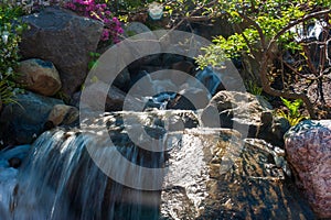 Beautiful small waterfall in a japanese style garden