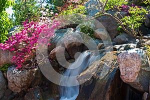 Beautiful small waterfall in a japanese style garden