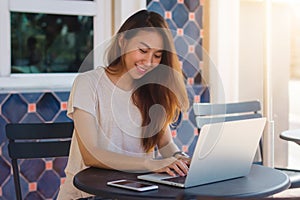 Beautiful smart business freelance Asian woman in smart casual wear working and sending email on laptop or computer.