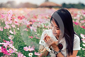 Beautiful smile asian woman in the cosmos field.Vintage Style