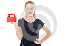 Beautiful smile blonde holding gift over isolated background with surprise face pointing finger to himself,copy space