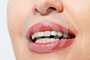 Beautiful smile with red lips and healthy white teeth isolated on white. Botox and collagen concept. Selective focus