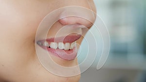 Beautiful smile with whitening teeth. Dental photo. Macro closeup of perfect female mouth, lipscare rutine. Happy