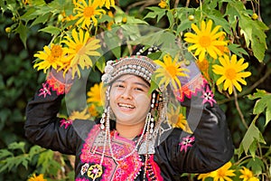 Beautiful smile young hill tribe girl in sunflowers garden.