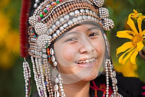 Beautiful smile young hill tribe girl in sunflowers garden.