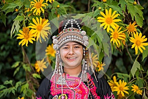 Beautiful smile young hill tribe girl in sunflowers garden.