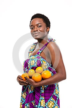 Beautiful smiling african american woman standing and holding oranges