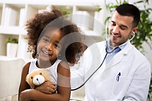 Beautiful smiling afro-american girl with her pediatrician