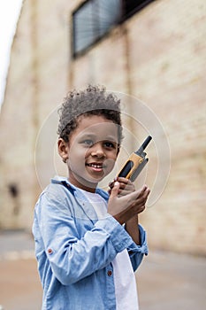 beautiful smiling afro boy with portable