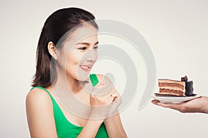 Beautiful smiling asian young woman with a chocolate cake isolated on white background.