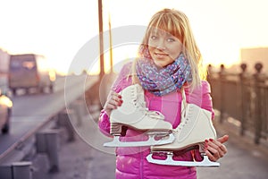 Beautiful smiling blond woman with ice skates