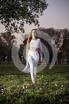 Beautiful and smiling blondie girl, autumn in the park