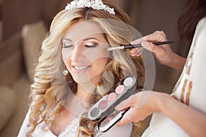 Beautiful smiling bride wedding portrait with makeup and hairsty