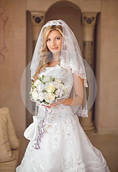 Beautiful smiling bride woman with bouquet of flowers, wedding m