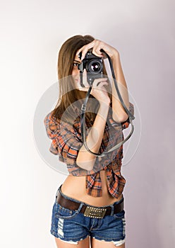 Beautiful smiling brunette girl with a camera