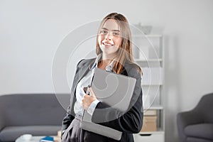 Beautiful smiling Business woman freelancer using laptop typing on pc notebook, surfing internet in office.