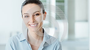 Beautiful smiling business woman posing in the office