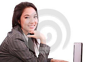 Beautiful smiling business woman working on laptop