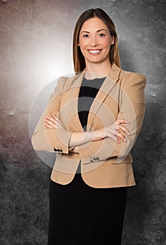 Beautiful smiling businesswoman arms folded standing