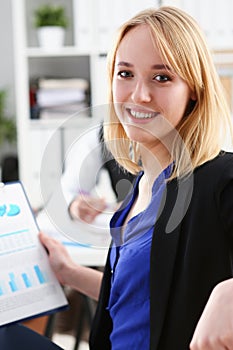 Beautiful smiling cheerful girl at workplace