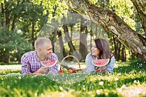 Beautiful, smiling couple lying in the park