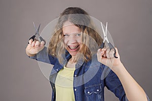 Beautiful smiling curly hair girl with scissors