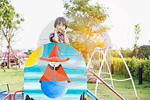 Beautiful smiling cute girl on a playground